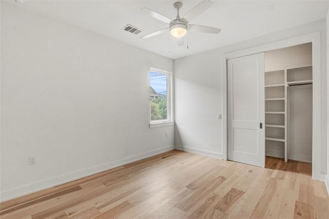 Unfurnished bedroom featuring light wood-style floors, baseboards, a closet, and ceiling fan | Image 28