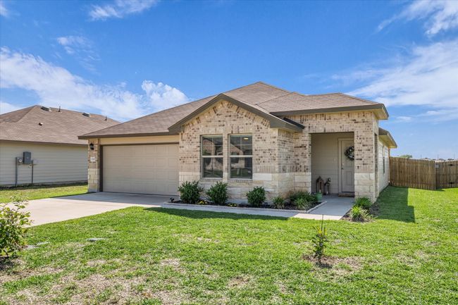 View of front facade featuring brick siding, driveway, a garage, and roof with shingles | Image 28