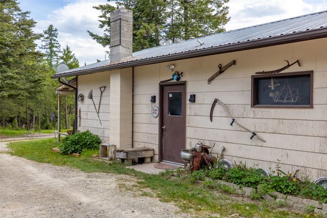 Entrance to property with metal roof and a chimney | Image 11