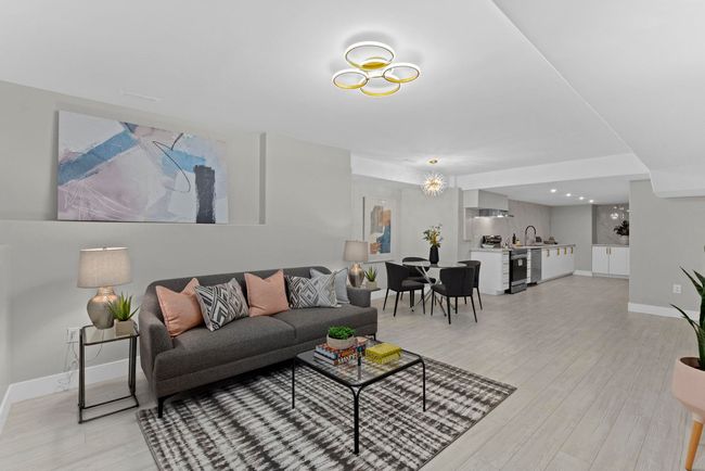 Living room featuring baseboards and light wood-type flooring | Image 30
