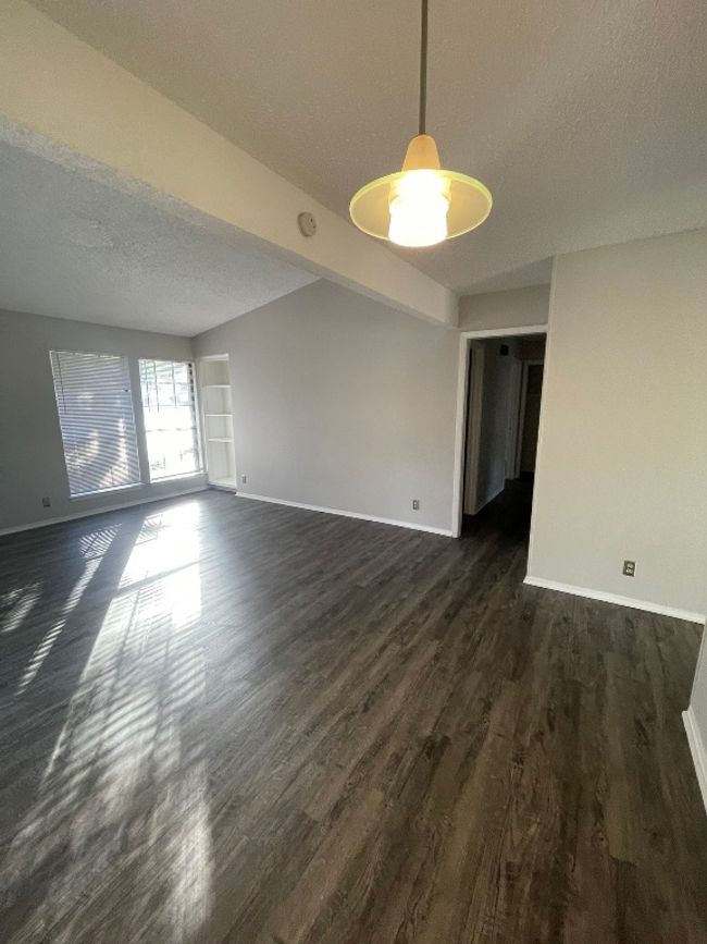 Spare room with a textured ceiling and dark wood-type flooring | Image 13