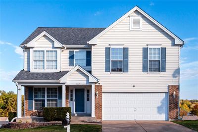 View of front facade featuring a garage | Image 1