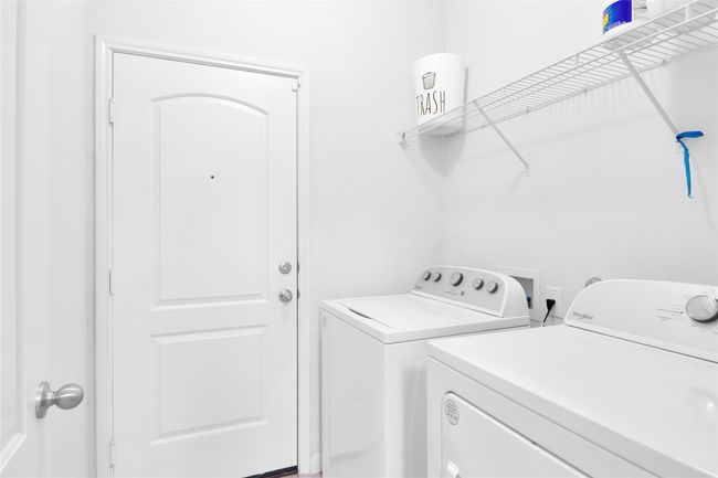 Washroom featuring washer and clothes dryer and laundry area | Image 13