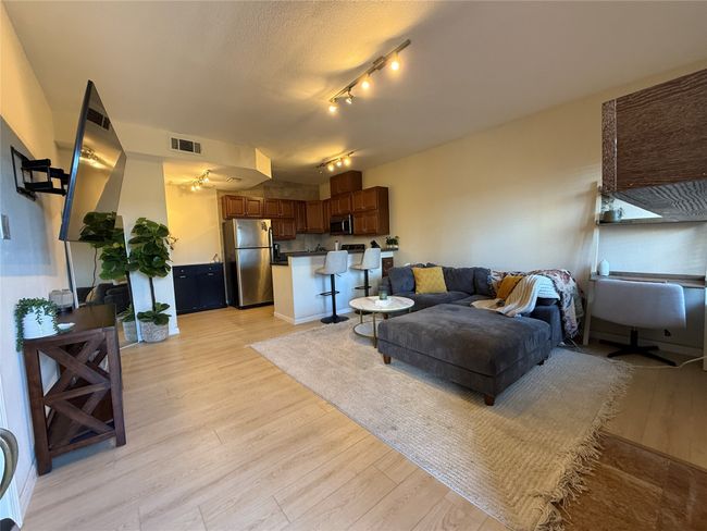 Living room featuring visible vents and light wood-style flooring | Image 7
