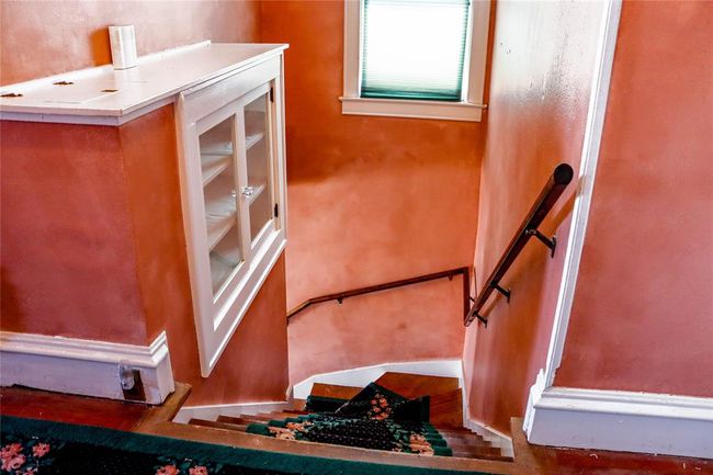 There are more built-ins at the stop of the staircase, and a laundry drop too. | Image 24