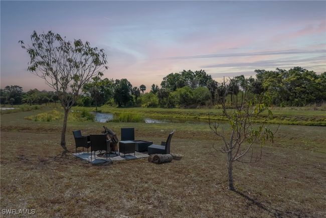 View of yard featuring a patio, view of wooded area, and a water view | Image 21