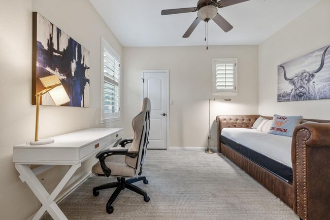 Upper level bedroom featuring healthy amount of natural light, a ceiling fan, and baseboards | Image 25