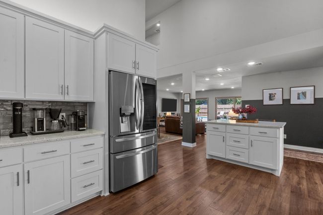 Kitchen featuring stainless steel appliances, white cabinetry, recessed lighting, and open floor plan | Image 6