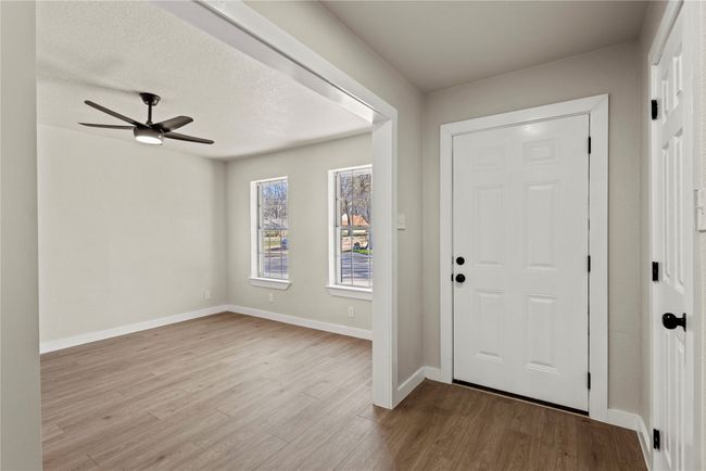 Foyer entrance featuring light wood-style floors, ceiling fan, a textured ceiling, and baseboards | Image 16