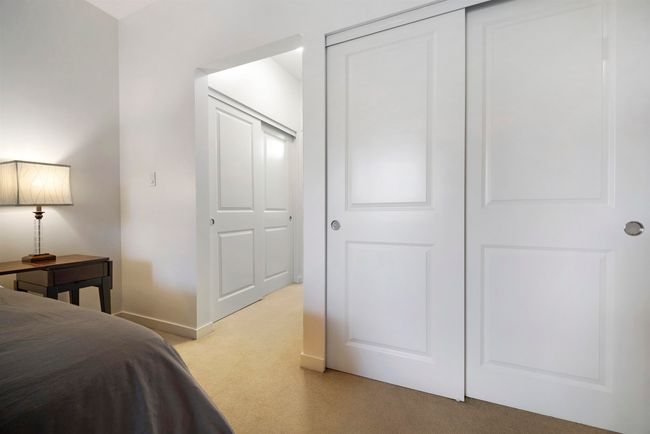 Bedroom featuring baseboards, a closet, and light colored carpet | Image 17