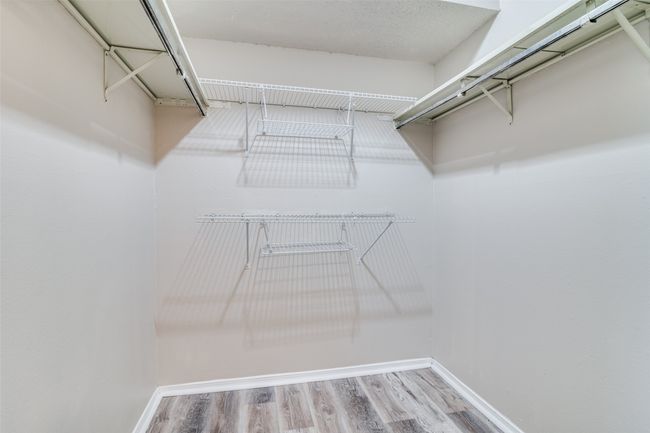 Spacious closet with wood finished floors | Image 13