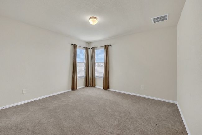 Empty room with carpet flooring, baseboards, and visible vents | Image 29