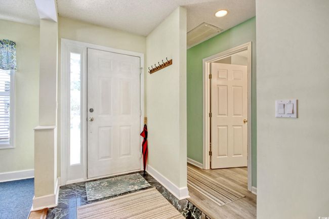 Entryway featuring wood finished floors, a textured ceiling, and recessed lighting | Image 8