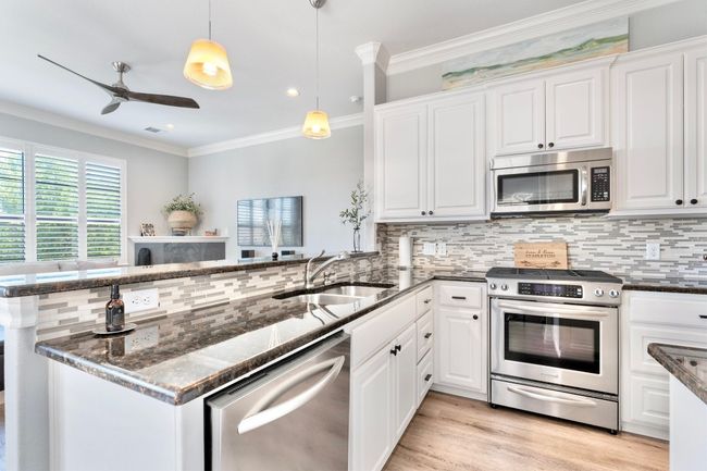 Gourmet kitchen featuring stainless steel appliances. | Image 6