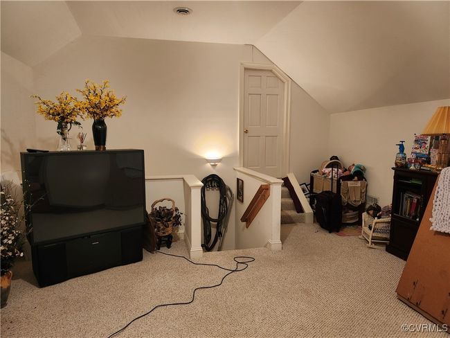 Bonus room upstairs featuring vaulted ceiling, visible vents, and carpet flooring | Image 18