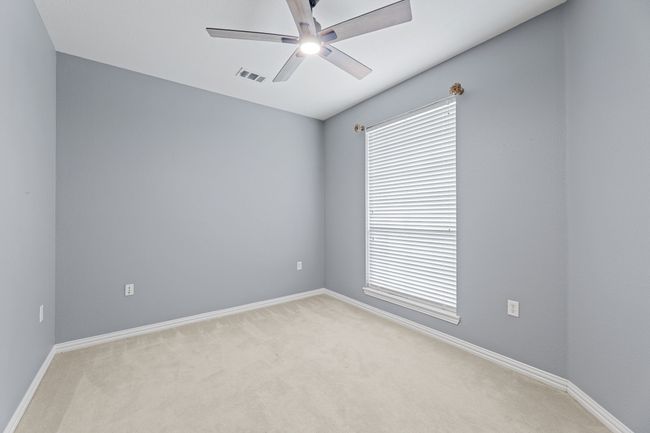 Spare room featuring ceiling fan and light colored carpet | Image 9