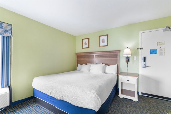 Carpeted bedroom featuring baseboards | Image 18