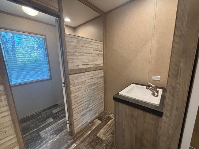 Bathroom featuring walk in shower, wood finished floors, and vanity | Image 16