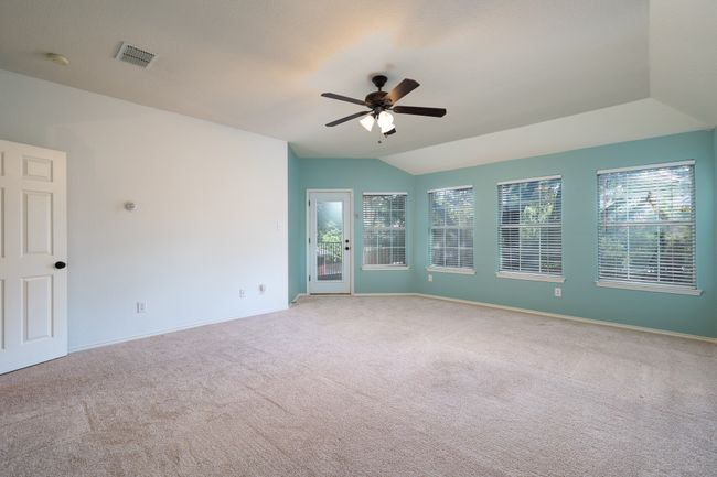 Carpeted spare room with plenty of natural light, lofted ceiling, ceiling fan, and a smoke detector | Image 28