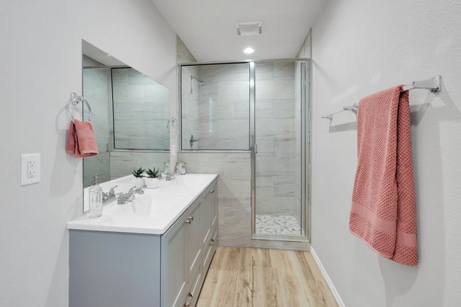 GORGEOUS primary bathroom that has a retreat feel. You are going to love the walk in shower and dual sinks | Image 11