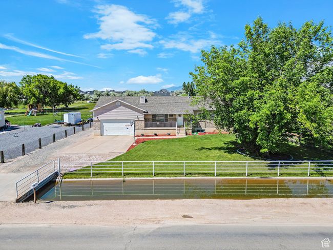 View of front of property featuring driveway, a garage, and brick siding | Image 42