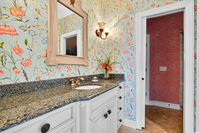 Bathroom with wallpapered walls, vanity, and tile patterned flooring | Image 17