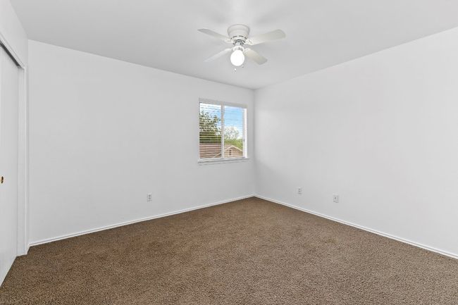 Unfurnished room featuring dark carpet and a ceiling fan | Image 27