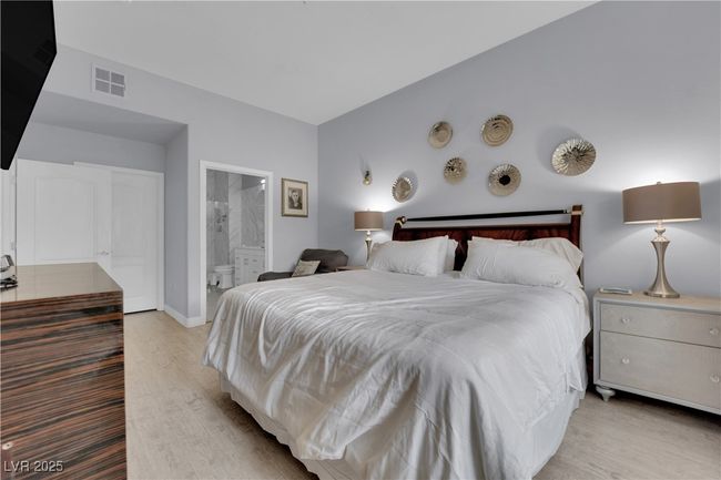 Bedroom with light wood-style floors and ensuite bath | Image 28