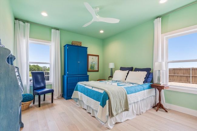 Bedroom with multiple windows, light wood-style flooring, recessed lighting, and baseboards | Image 32