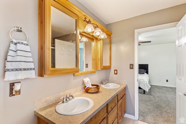 Ensuite bathroom featuring double vanity and baseboards | Image 14