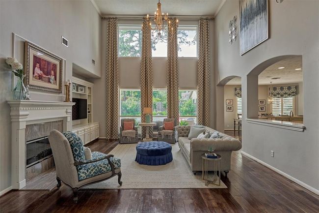 Family Room is open to Kitchen and Breakfast area. Beautiful windows allows for view of the stunning backyard. Fireplace and built-ins add to the charm. | Image 10