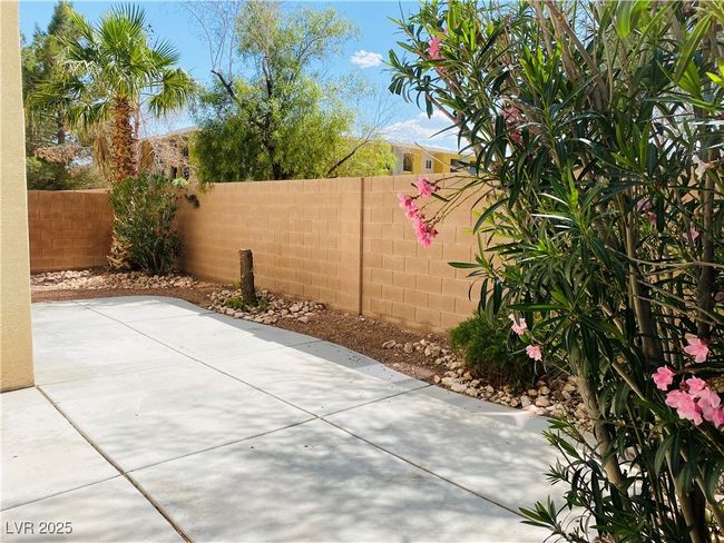 View of patio with a fenced backyard | Image 5