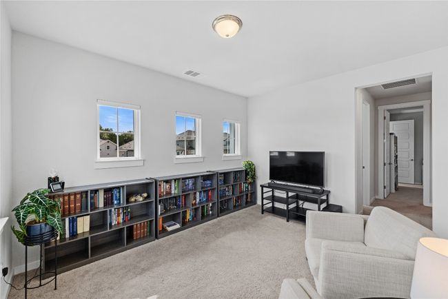 Carpeted living area featuring visible vents | Image 14