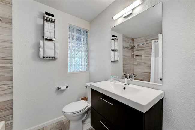A beautifully built full bathroom with a window and bright lighting. | Image 25