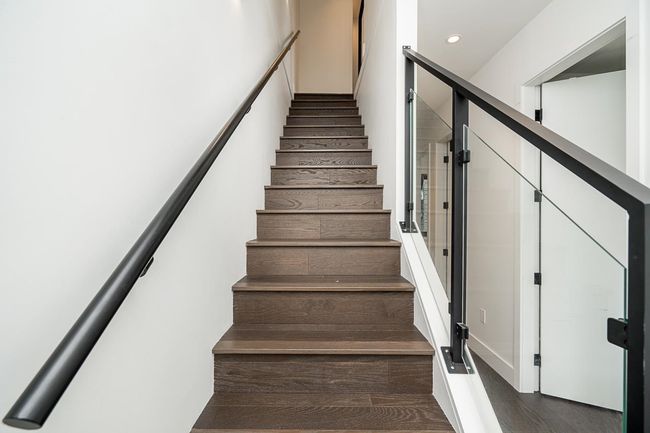 Stairs with wood finished floors and recessed lighting | Image 23