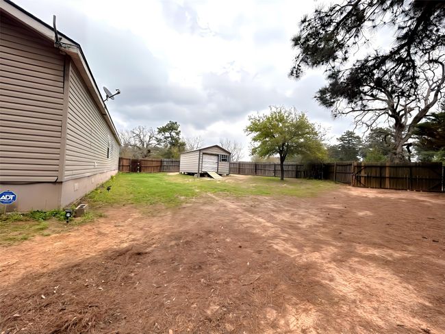 View of yard with an outdoor structure, a fenced backyard, and a shed | Image 33