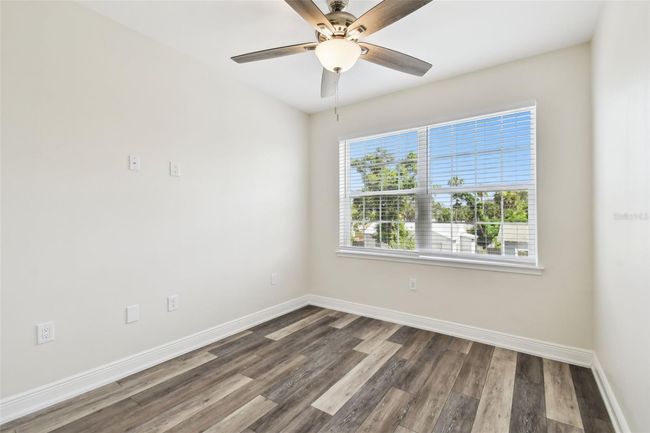 Bedroom 2 - fresh paint, ceiling fan, blinds and large window overlooking front of home. | Image 26