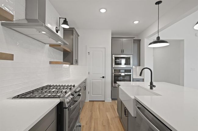 Island kitchen with grey cabinets and quartz countertops (*Photo not of actual home and used for illustration purposes only.) | Image 10