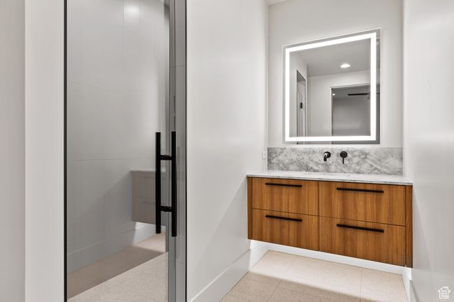 Bathroom featuring baseboards, tasteful backsplash, and vanity | Image 44