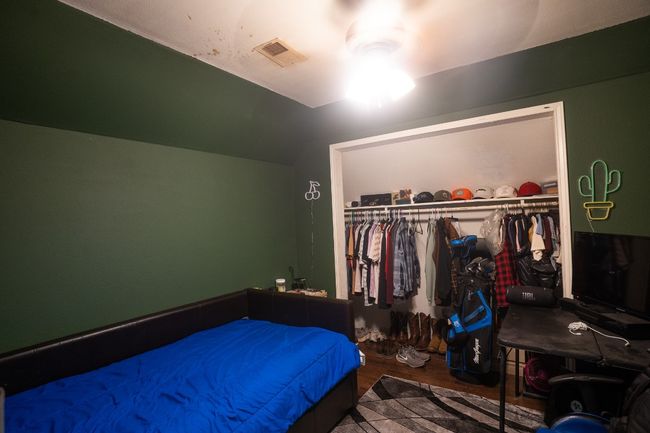 Bedroom featuring wood finished floors, a closet, and vaulted ceiling | Image 19