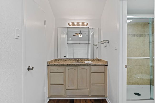 Upstairs ensuite bathroom with granite counters, decorative lighting and custom tile shower. | Image 22