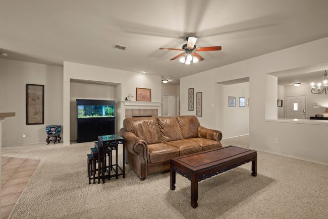 Comfortable living area with open sight lines to the front room, giving the home an airy and connected feel. | Image 14