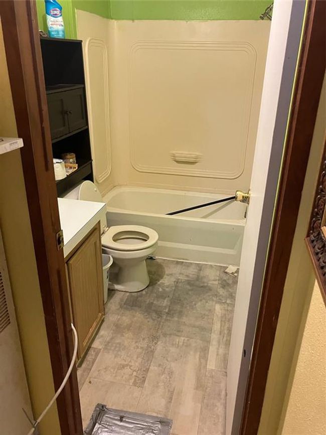 Full bathroom featuring shower / tub combination, vanity, tile patterned floors, and toilet | Image 23