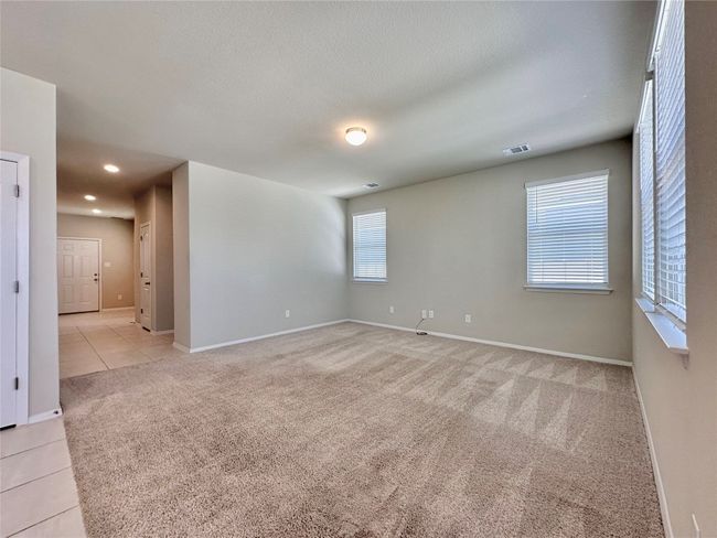 Spare room with light carpet, light tile patterned floors, and recessed lighting | Image 5