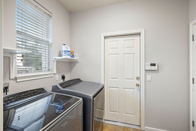 The large laundry room leads to the garage and also has a large, walk-in closet! | Image 22