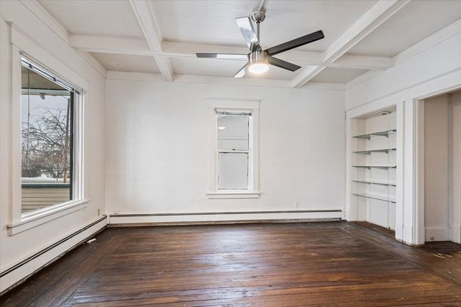 Spare room featuring beam ceiling, a wealth of natural light, and coffered ceiling | Image 5