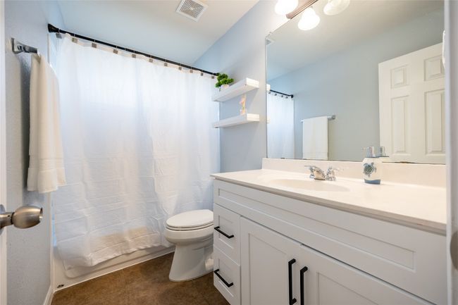 Bathroom featuring vanity and curtained shower | Image 18