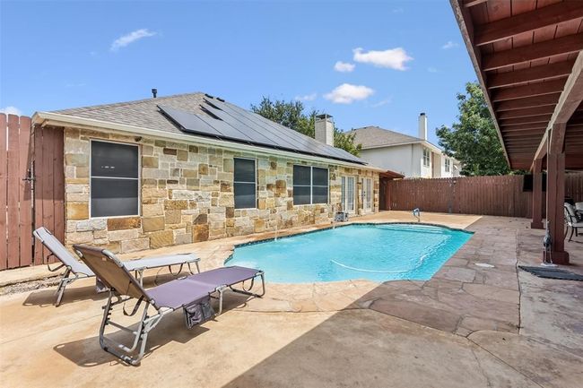 View of swimming pool with a fenced in pool, a fenced backyard, and a patio area | Image 21