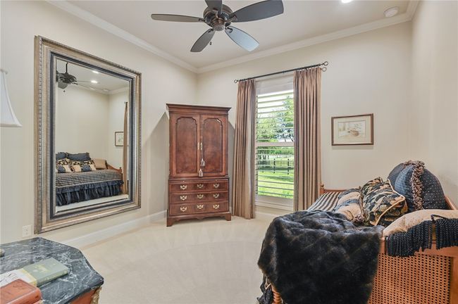 Living area featuring light colored carpet, ceiling fan, crown molding, and baseboards | Image 5