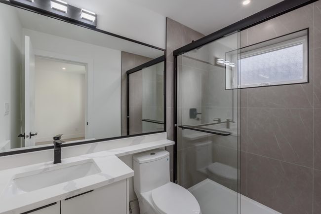 Full bathroom featuring vanity, toilet, and a stall shower | Image 28